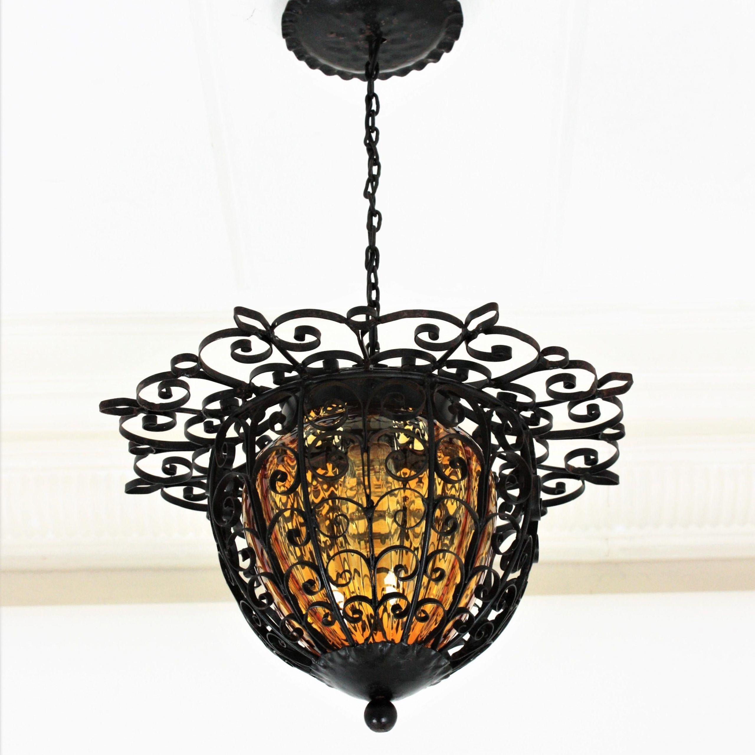 Blackened Iron Lantern Chandeliers For Fashionable Spanish Lantern Pendant Light In Wrought Iron With Amber Blown Glass Shade  For Sale At 1stdibs (View 8 of 15)